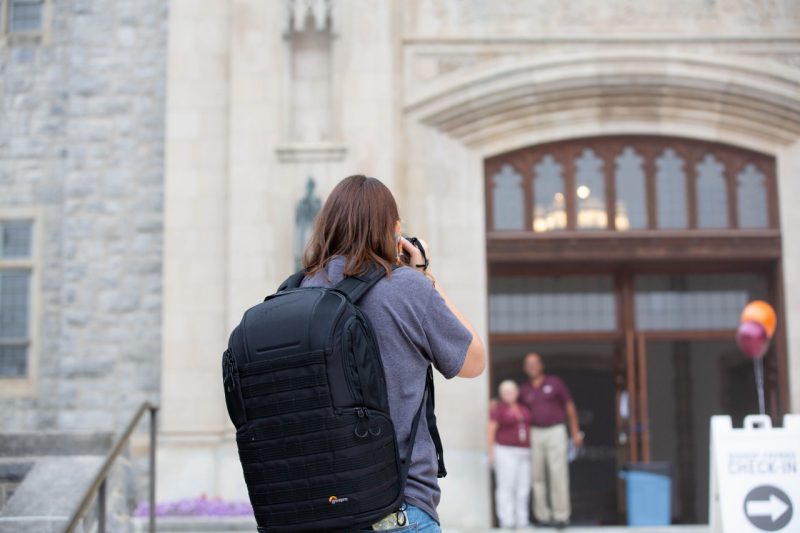 Photographer snaps a photo of Open House staff.